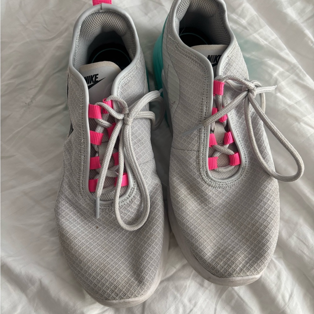 Nike Pink and White Athletic Shoes with Sleek Design